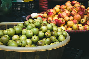 Fresh Green and Red Apples in Baskets at Market