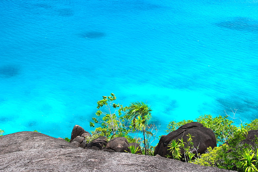 Tropical Cliff View Over Vibrant Turquoise Ocean Water