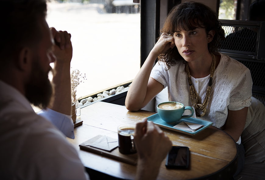 Serious Business Meeting Between Colleagues In Modern Cafe