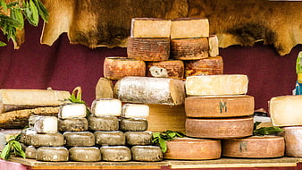Assorted Spanish Cheeses Displayed at a Market Stall