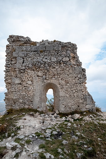 Ancient stone ruins with archway on mountain top
