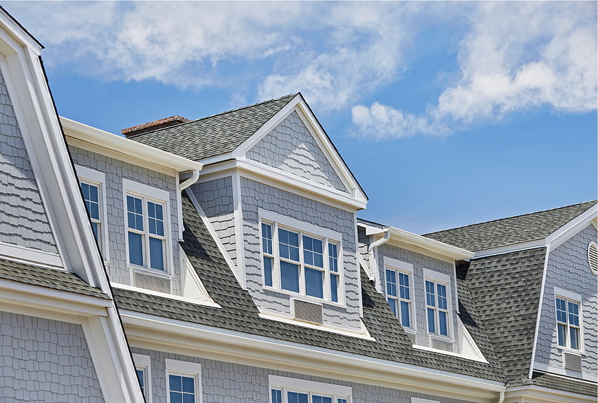 Gray Shingle House Exterior with Blue Sky Background