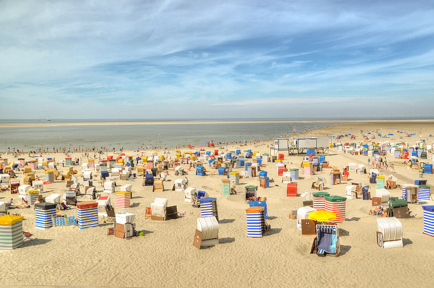 Colorful Beach Huts on Sandy Shore with Ocean View