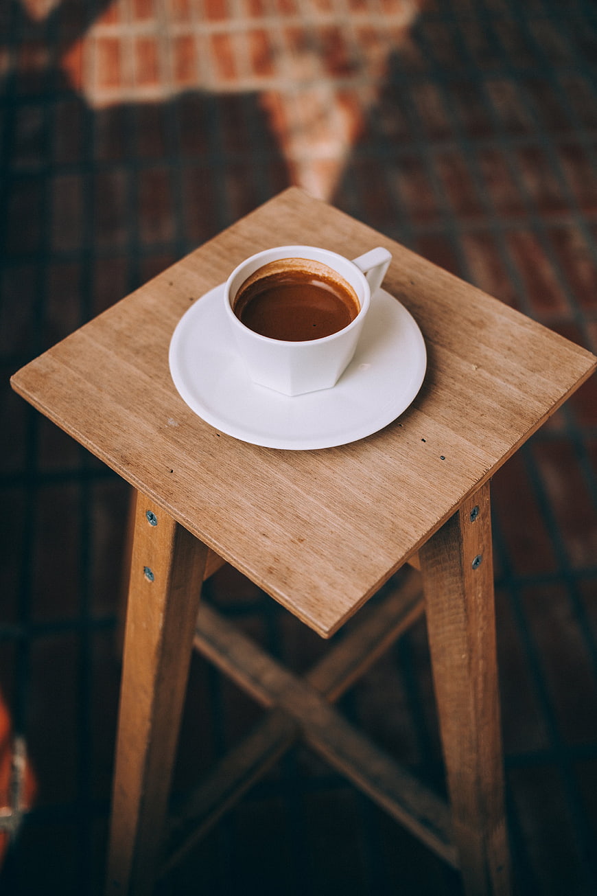 White Coffee Cup on Wooden Stool Top Down View