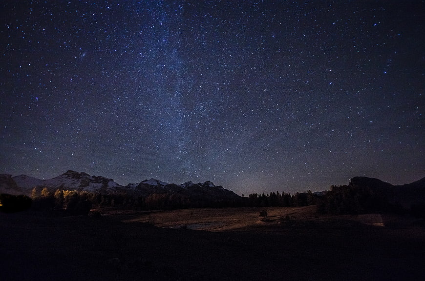 Milky Way Galaxy Over Snowy Mountain Range at Night