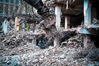 Excavator Demolishing Building Structure With Concrete Debris And Rebar