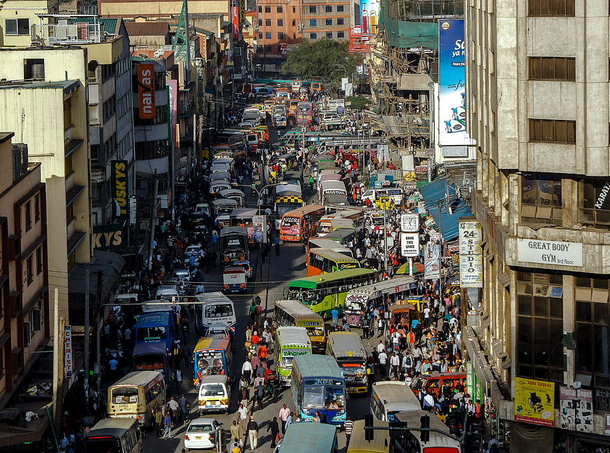 Busy Nairobi street traffic with matatus and pedestrians