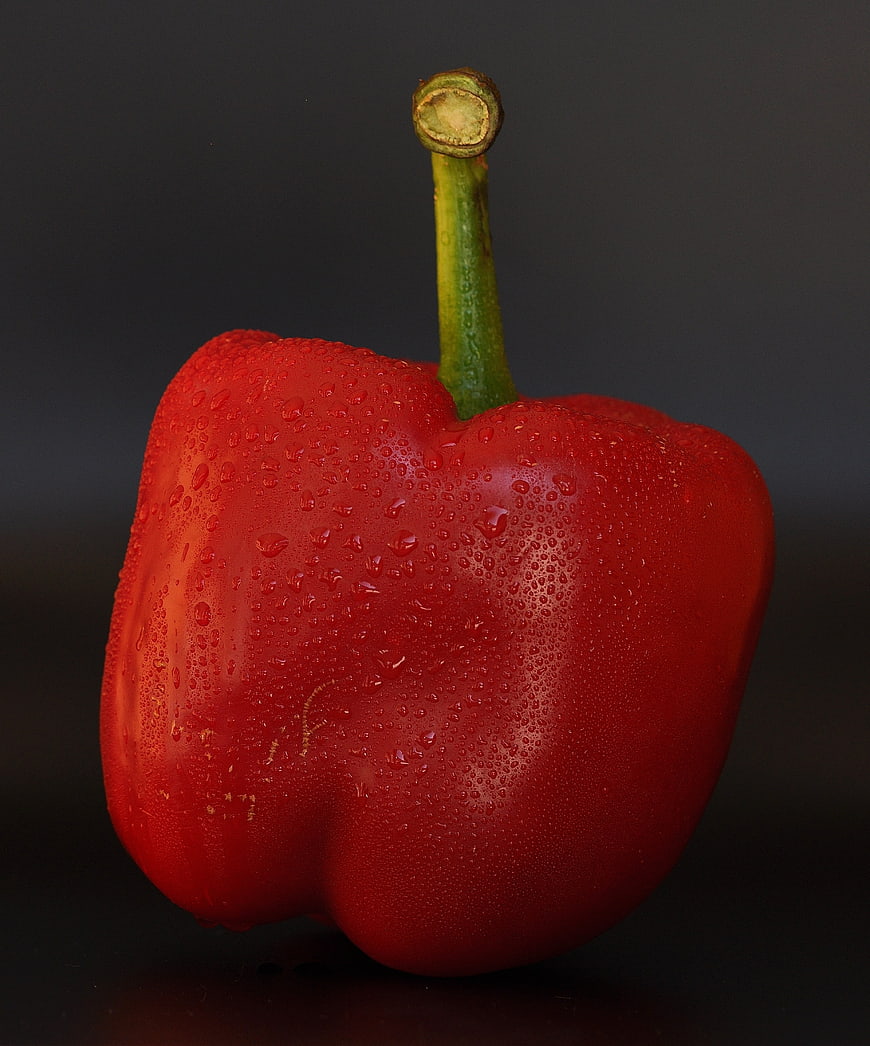 Fresh Red Bell Pepper With Water Droplets On Dark Background