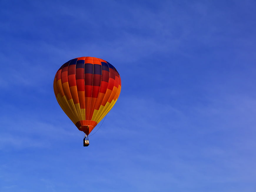Colorful Hot Air Balloon Flying in Blue Sky