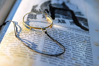Vintage Magnifying Glass on Old German Text Book Page