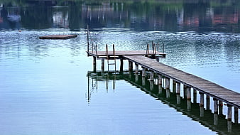 Wooden Dock Extending into Calm Blue Lake Water
