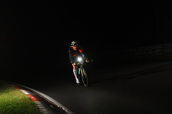 Cyclist Riding Road Bike at Night on Dark Track