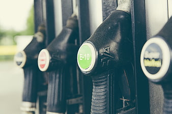 Close-up of E-10 fuel pump nozzles at a gas station