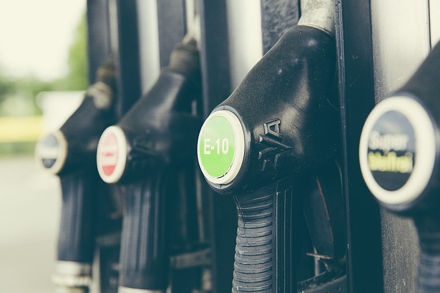 Close-up of E-10 fuel pump nozzles at a gas station