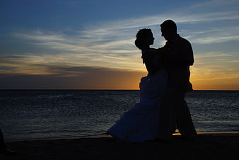 Silhouette of Wedding Couple Dancing on Beach at Sunset