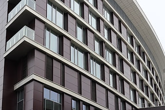 Modern curved apartment building facade with balconies