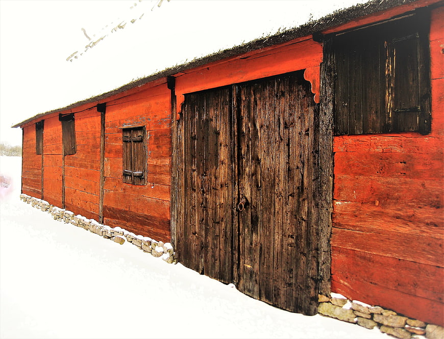 Traditional Red Wooden Farm Barn In Snowy Swedish Countryside