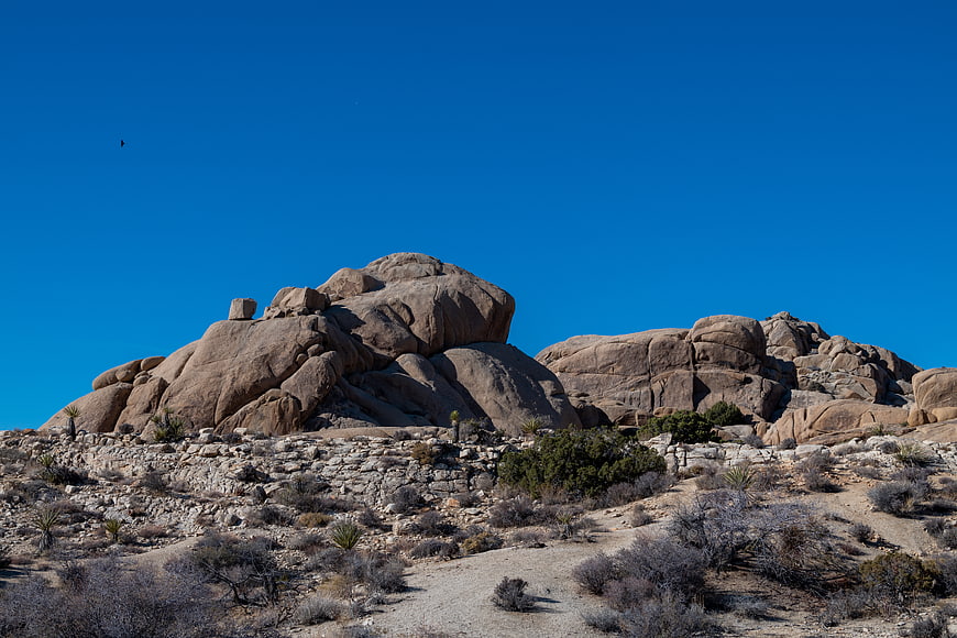 Desert Landscape with Large Rock Formations and Blue Sky