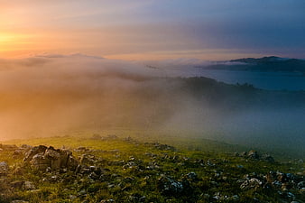 Misty Mountain Landscape at Sunrise with Fog and Lake
