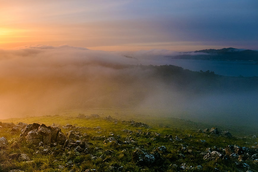 Misty Mountain Landscape at Sunrise with Fog and Lake