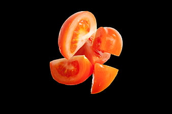 Fresh Sliced Tomatoes Floating on Black Background