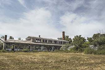 Abandoned Industrial Factory Building with Overgrown Grass