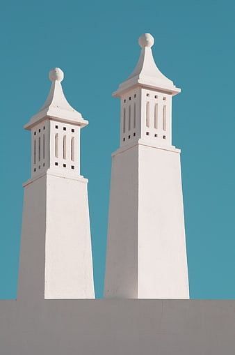 White architectural towers against a clear blue sky