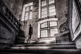 Girl standing on grand staircase in old building