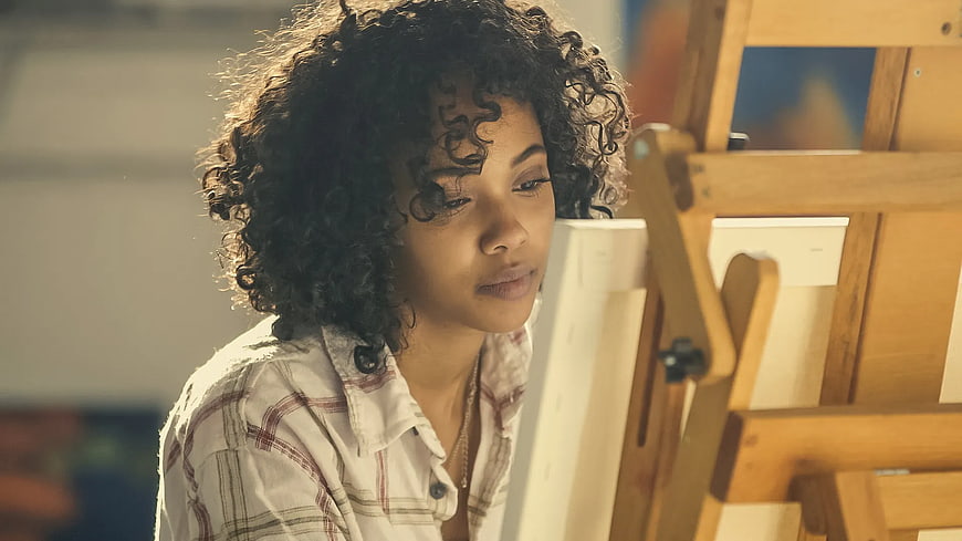 Young Woman Artist Painting at Wooden Easel