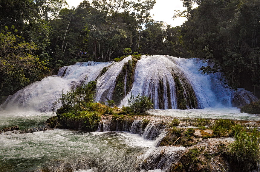 Majestic wide waterfall cascading through lush tropical forest
