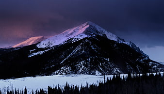Snow-Capped Mountain Peak at Twilight with Pink Alpenglow