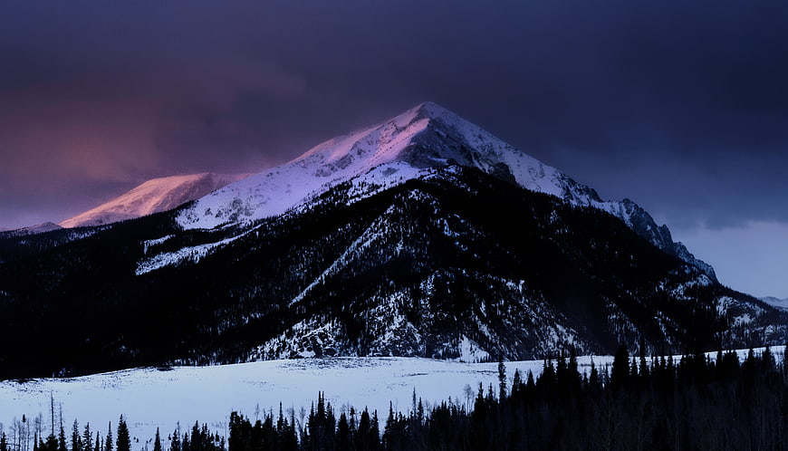 Snow-Capped Mountain Peak at Twilight with Pink Alpenglow
