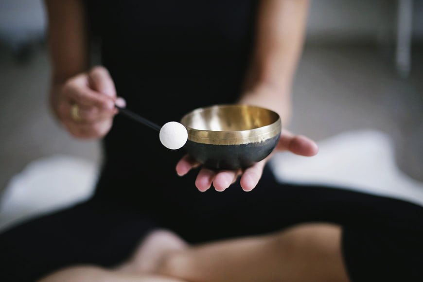 Woman holding singing bowl for meditation and mindfulness
