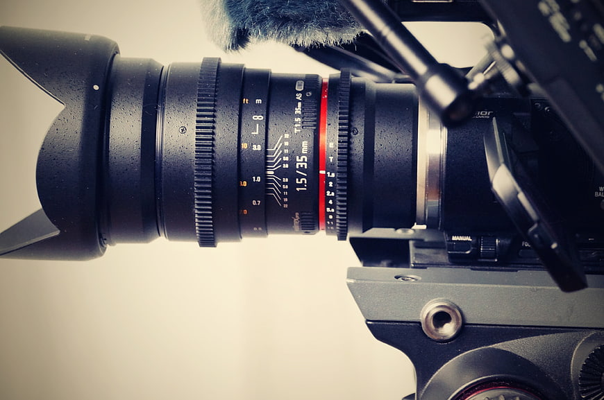 Close-up of professional video camera lens with microphone