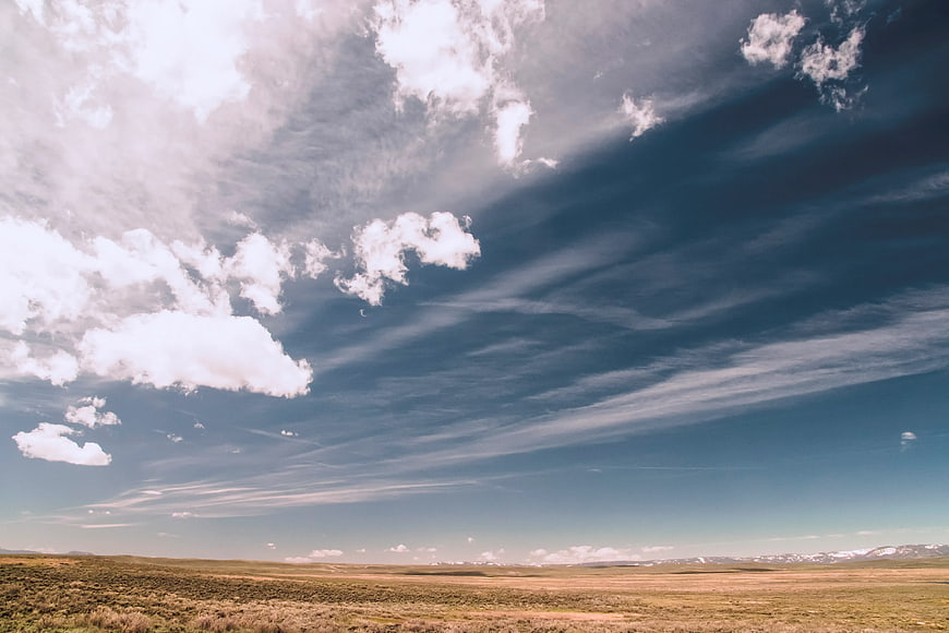 Vast Sky with White Clouds Over Golden Grassland