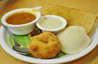 Traditional South Indian breakfast plate with idli, vada, and chutney