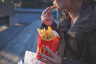 Woman Eating McDonald's French Fries Outdoors