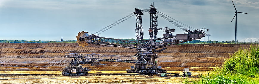 Panoramic view of massive bucket wheel excavator in open pit mine