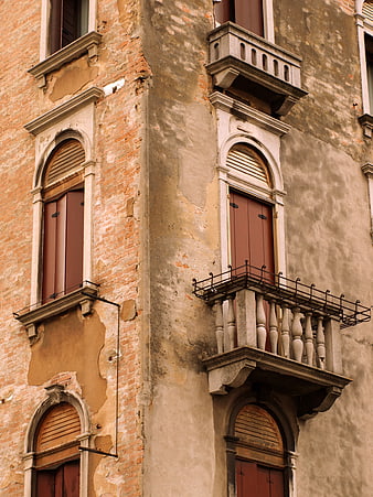 Old European Building Facade with Peeling Stucco and Balconies