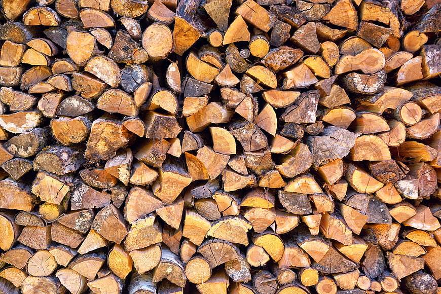 Stack of chopped firewood logs texture background