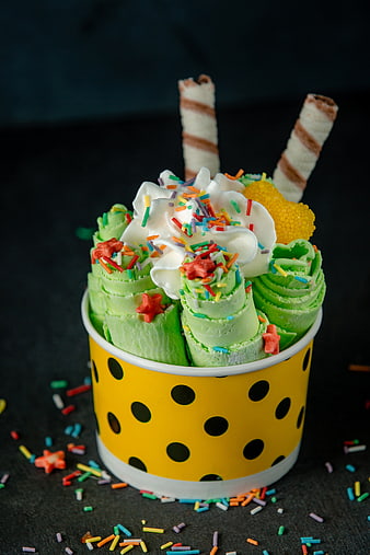 Green Rolled Thai Ice Cream with Sprinkles and Whipped Cream