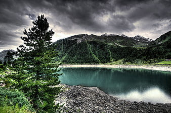 Dramatic HDR Alpine Lake with Stormy Sky and Pine Tree