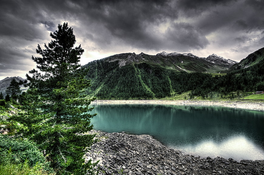 Dramatic HDR Alpine Lake with Stormy Sky and Pine Tree