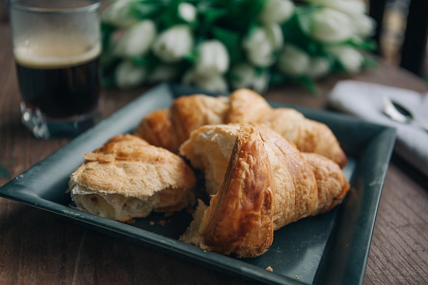 Fresh Croissants and Coffee on Dark Plate