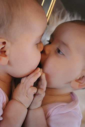 Baby Kissing Own Reflection In Mirror Close Up