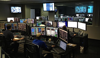 Mission Control Room with Engineers Monitoring Screens