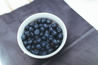 Top View of Fresh Blueberries in White Bowl on Dark Cloth
