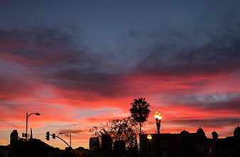 Vibrant Pink and Blue Sunset Sky Over City Silhouette