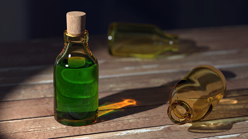 Green glass bottle with cork on rustic wooden table