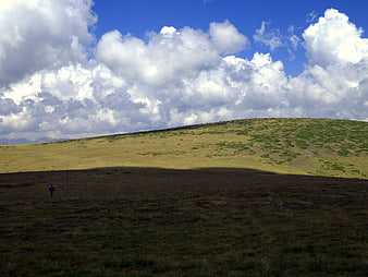 Lone Hiker in Shadowed Rila Mountains Landscape